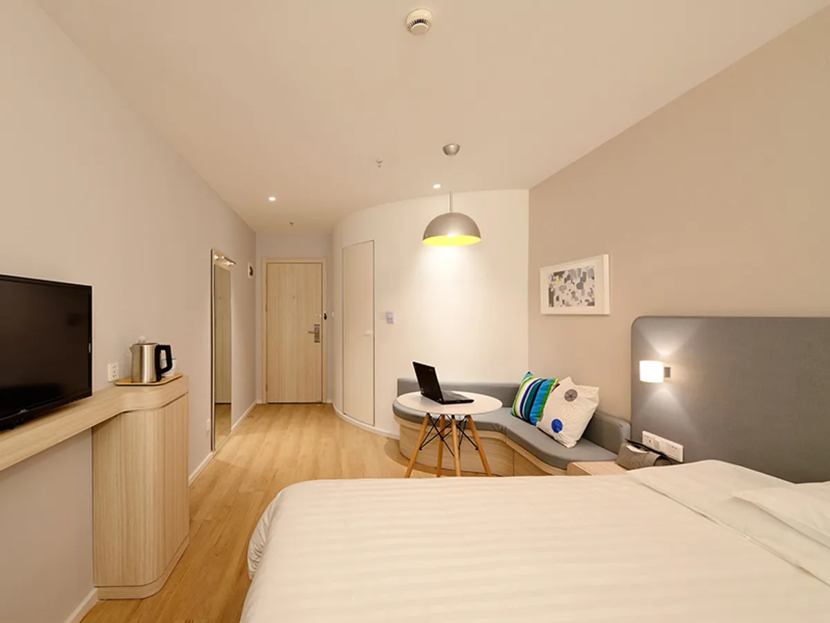 Courtyard Double — a bright room with white linen and timber floors
