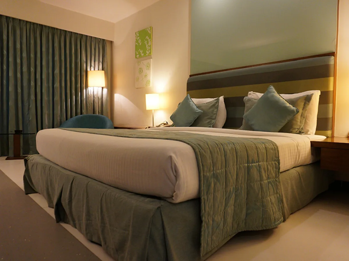 Premium King — warm timber, linen and soft evening light